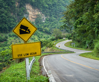 Use lower gears when traveling downhill and uphill